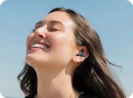 A woman listening with WallaBuds Pro Dot